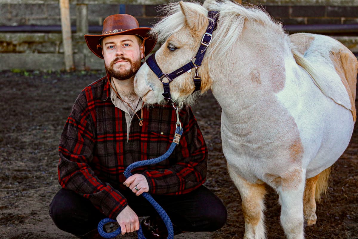 Jack Silver beside a Shetland pony during the Tiny Horse video project